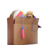 Box of used toys for a removal, garage sale, auction, or donation to a charitable organization. Isolated on white background.